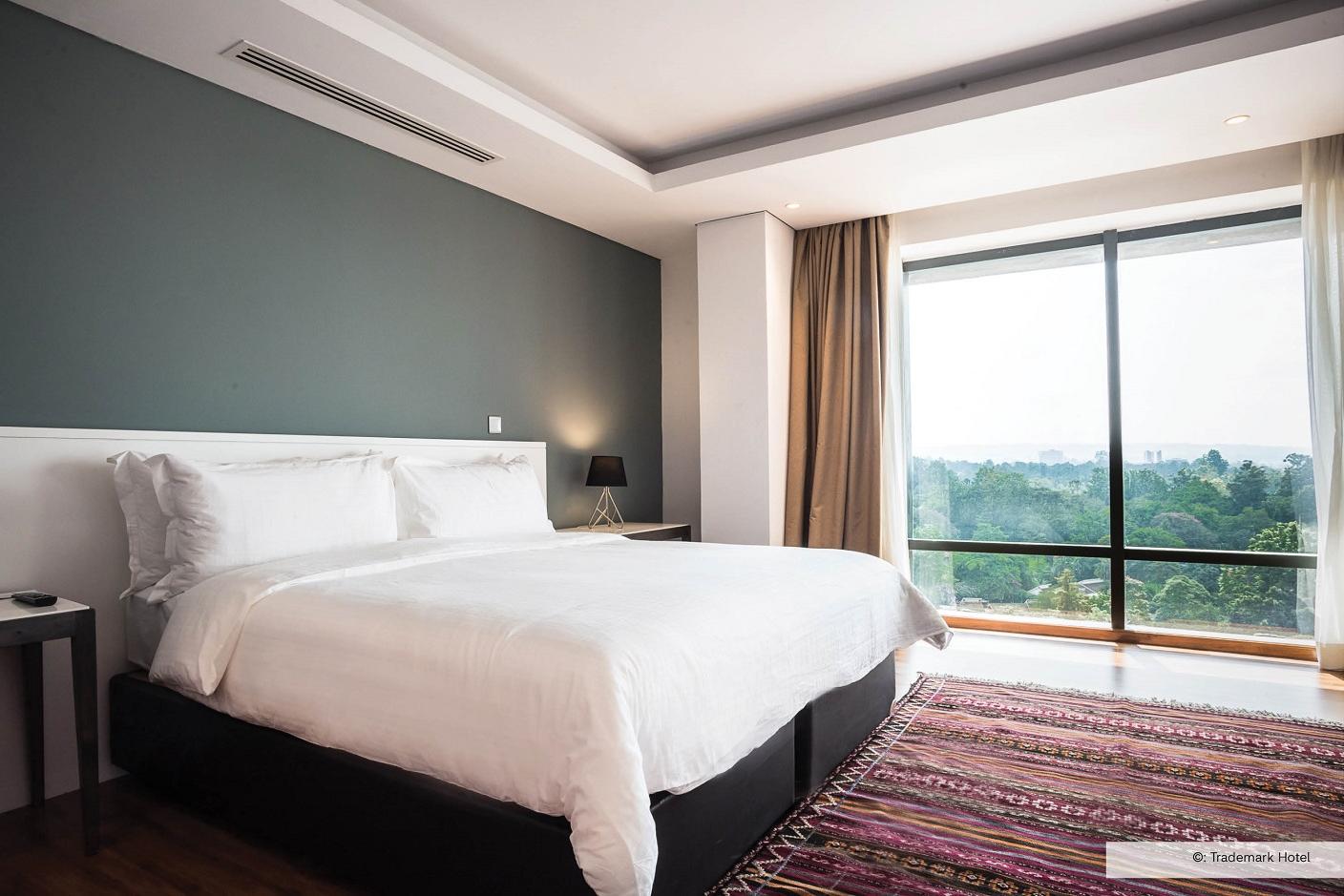 Bright hotel bedroom with big window