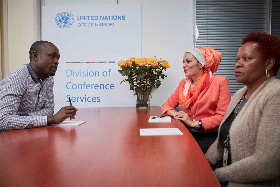Three UNON / Division of Conference Services Staff planning for an upcoming event at the United Nations Office at Nairobi complex.