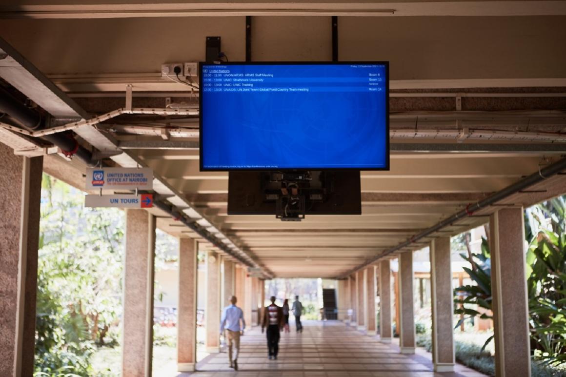 Digital Signage monitor hanging from the roof, displaying the meetings of the day, at the United Nations Office at Nairobi complex.