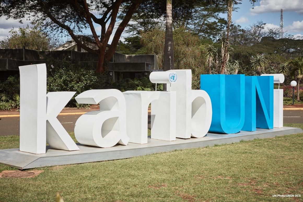 KaribUNi sign in big white letters with UN in blue on main lawn in UNON facility