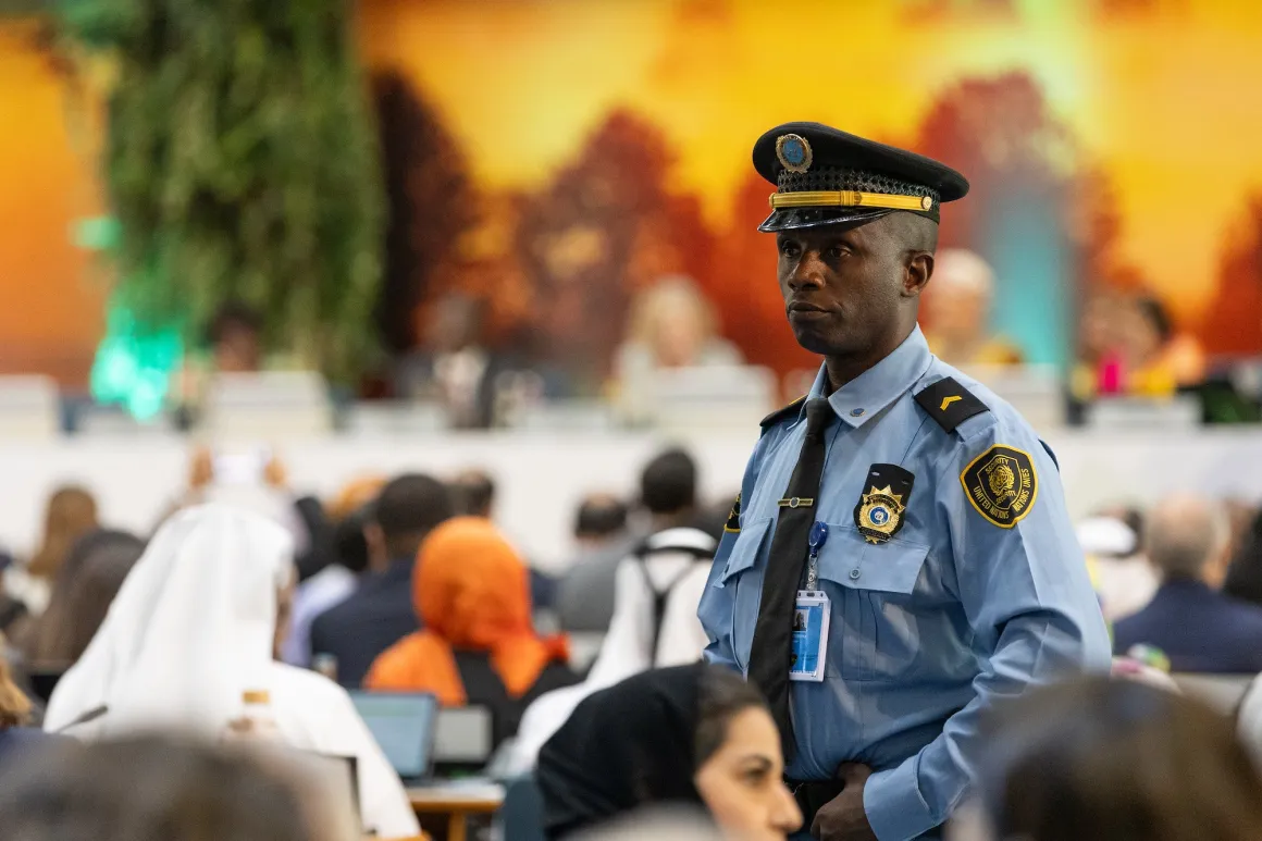 A man in a security uniform keeps watch
