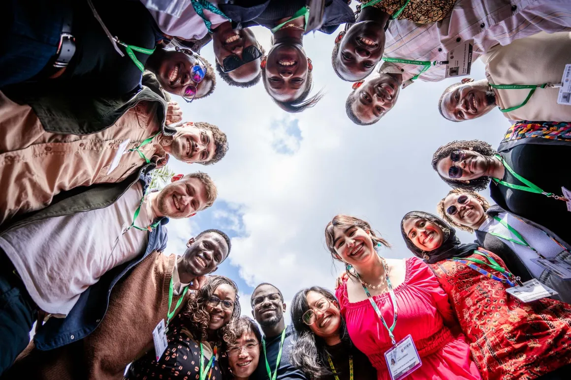 A group of people in a circle smiling