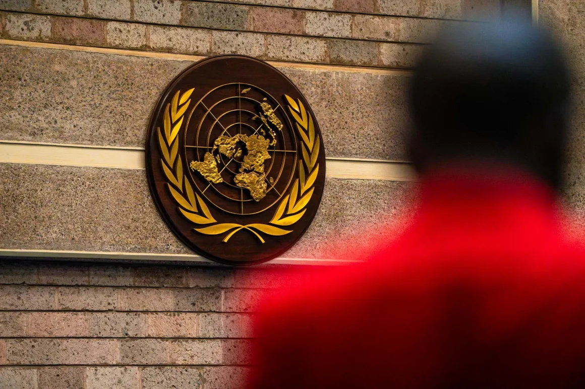 iisd-enbdanny_skilton_un_seal_sbstta28_sbi7_6august2026.jpg A person walks under the United Nations emblem