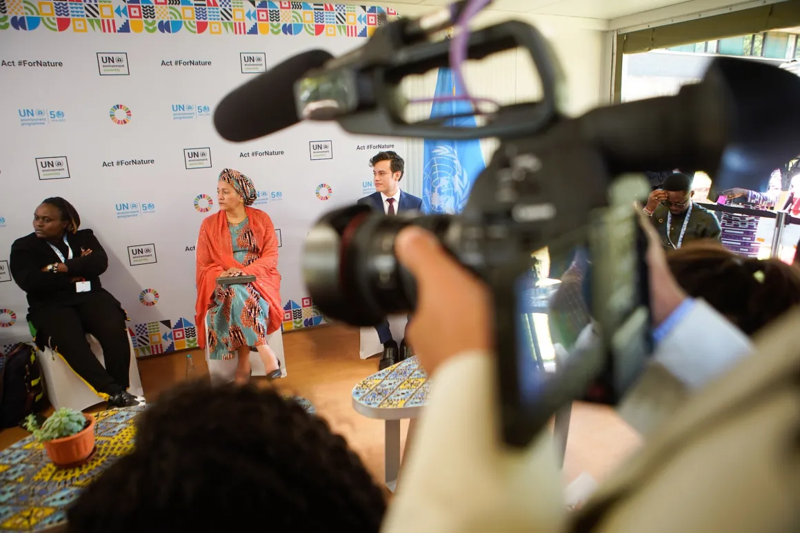 Journalists film an event